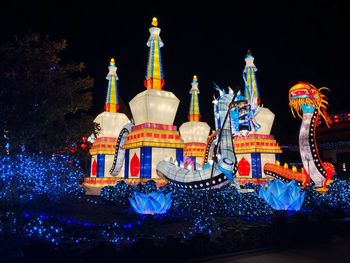 Low angle view of illuminated building against sky at night