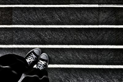 Low section of woman standing on tiled floor