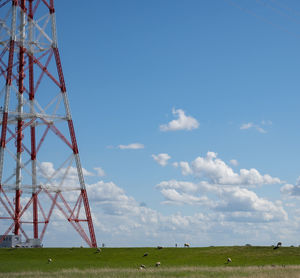 Low angle view of communications tower against sky