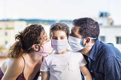 Happy family with protective masks