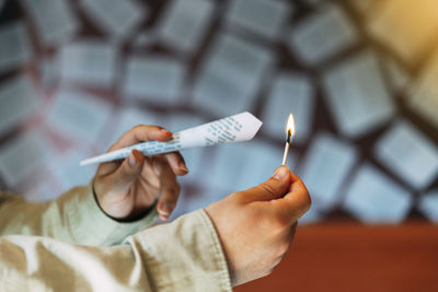 Close-up of man holding cigarette