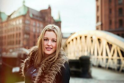 Portrait of a smiling young woman in city