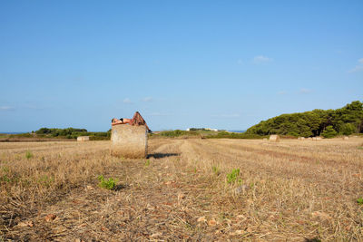 Built structure on field against sky