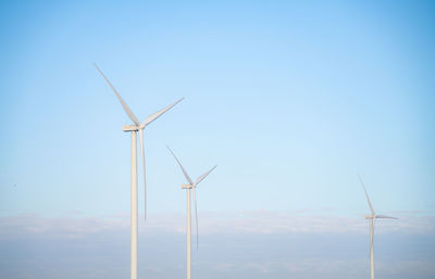 Low angle view of electricity pylon against clear sky