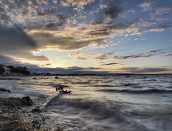 Scenic view of beach against sky during sunset