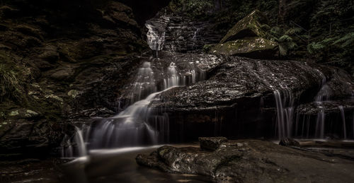 Scenic view of waterfall in rainforest