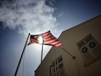 Low angle view of american flag against sky