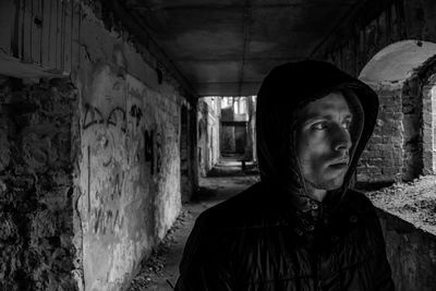 Man in corridor of abandoned building