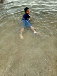 High angle view of boy playing on beach