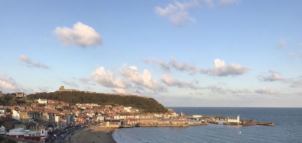 Panoramic view of townscape by sea against sky
