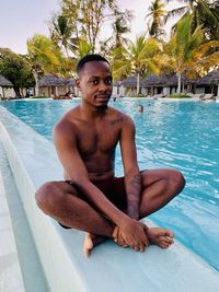 Portrait of shirtless boy swimming in pool