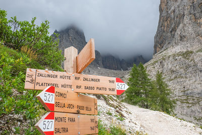 Information sign on rock against mountains