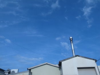 Low angle view of buildings against blue sky