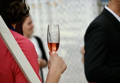 Midsection of a woman drinking glass