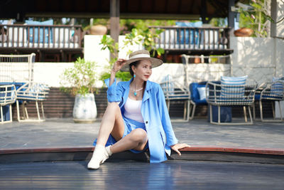 Portrait of woman sitting in swimming pool