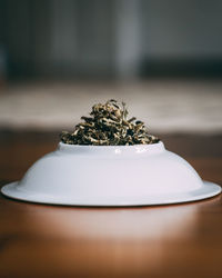 Close-up of tea leaves in plate on table