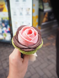 Close-up of hand holding ice cream