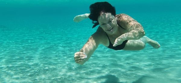 Woman swimming in sea