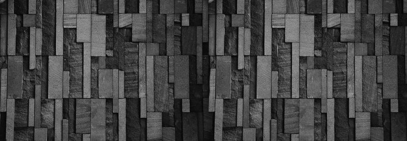 Panorama black stone wall pattern background for design in your work.