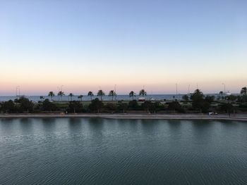 View of city at waterfront during sunset