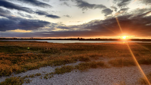 Scenic view of land against sky during sunset