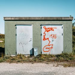 Graffiti on wall against clear sky