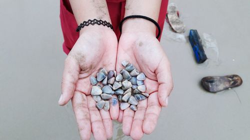 Close-up of hands holding pebbles