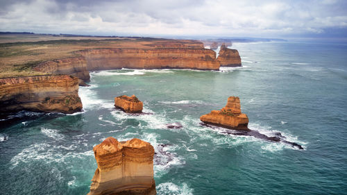 Scenic view of rocks in sea against sky