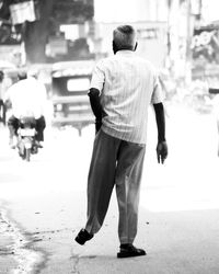 Rear view of men walking in city