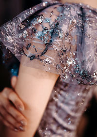 Female fashion details of blue blouse with silver sequins