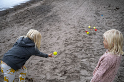 Girls playing boules on beach