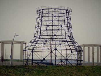 Electricity pylon on field against sky