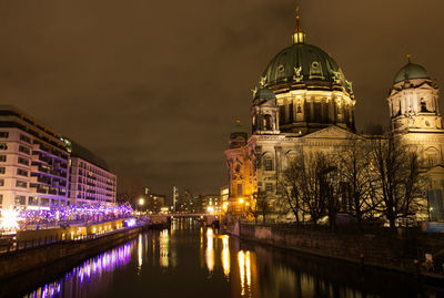 Reflection of illuminated buildings in city at night