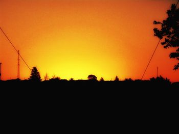 Silhouette landscape against clear sky during sunset