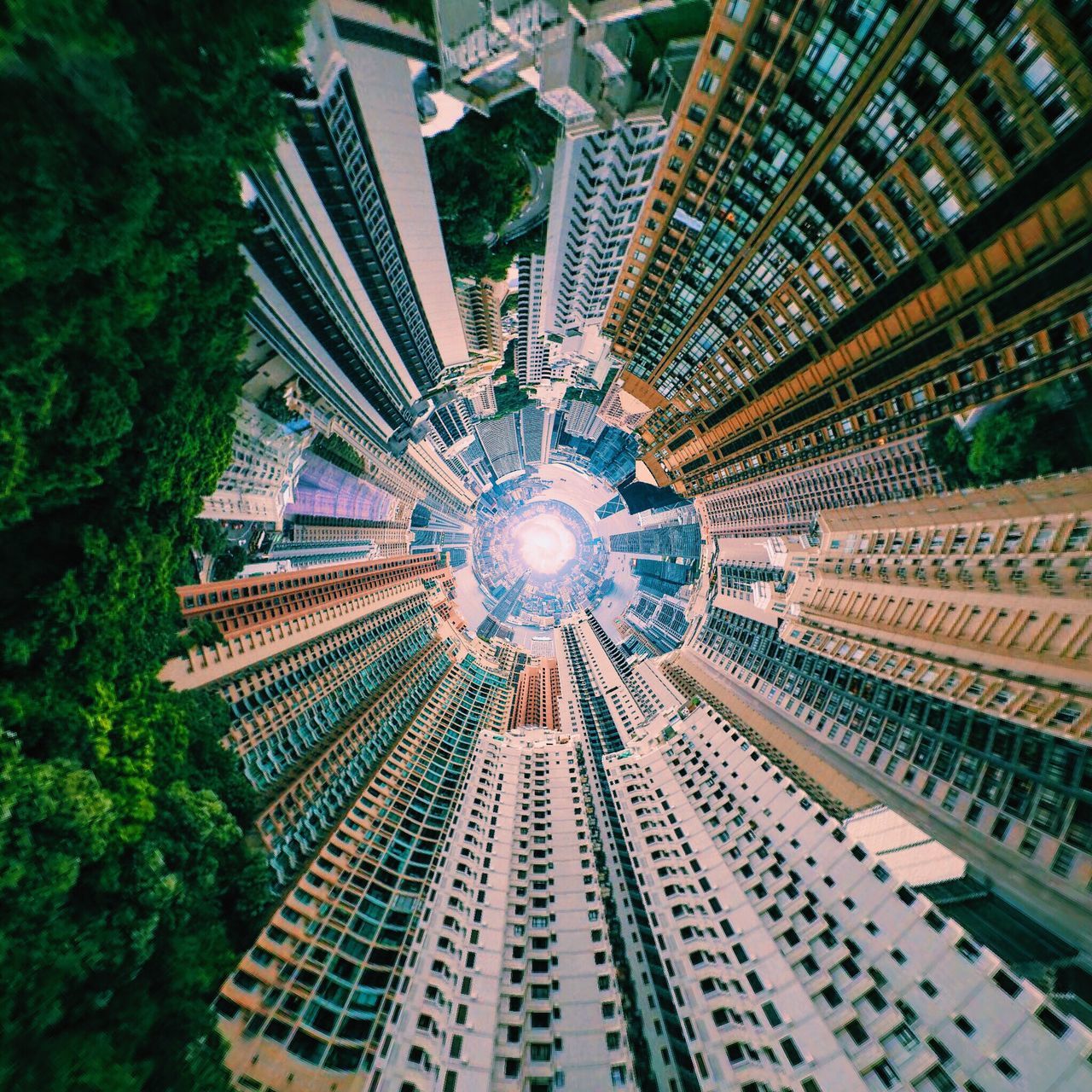 low angle view, illuminated, modern, architecture, built structure, ceiling, lighting equipment, skyscraper, tall - high, tower, directly below, city, electric light, geometric shape, sky, city life, architectural feature, creativity, diminishing perspective, spire