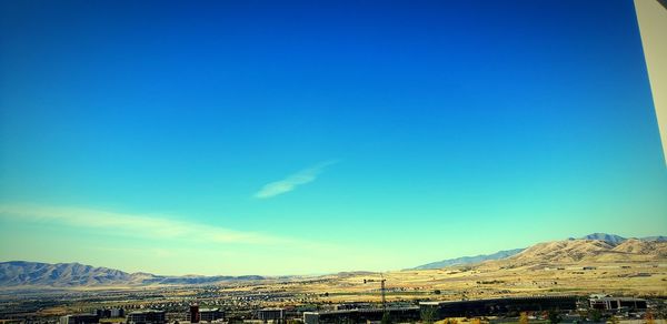 Scenic view of mountains against blue sky