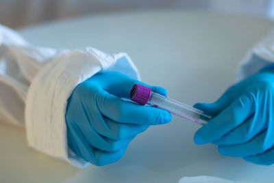 Close-up of healthcare worker holding test tube