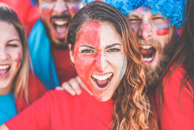 Portrait of happy soccer fans cheering