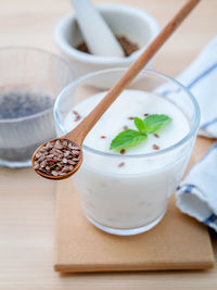 Drink in glass with wooden spoon on table