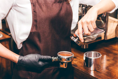 Midsection of man having coffee