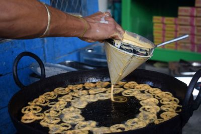 Midsection of person preparing food in kitchen