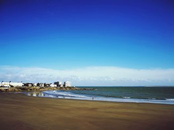 Scenic view of sea against blue sky