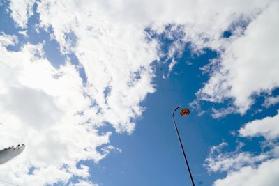 Low angle view of street light against cloudy sky