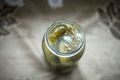 Close-up of cucumber pickle in jar on table