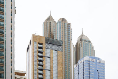 Low angle view of skyscrapers against clear sky