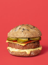 Close-up of burger against red background