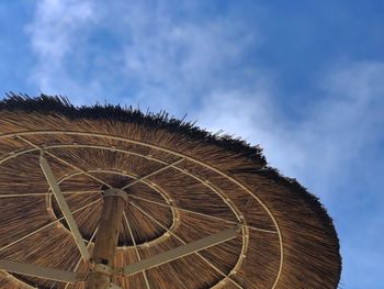 Low angle view of parasol against sky