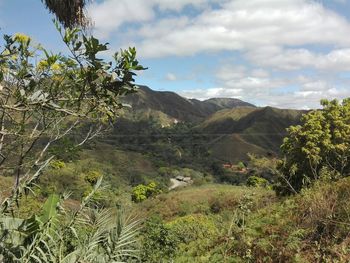 Scenic view of mountains against cloudy sky