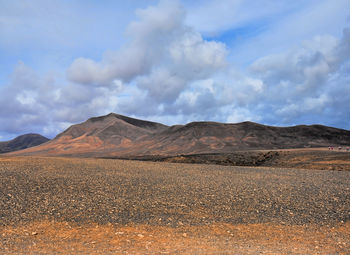 Scenic view of arid landscape against sky