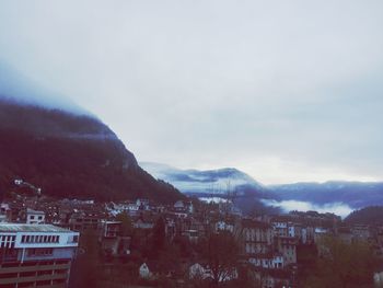 Houses in town against sky